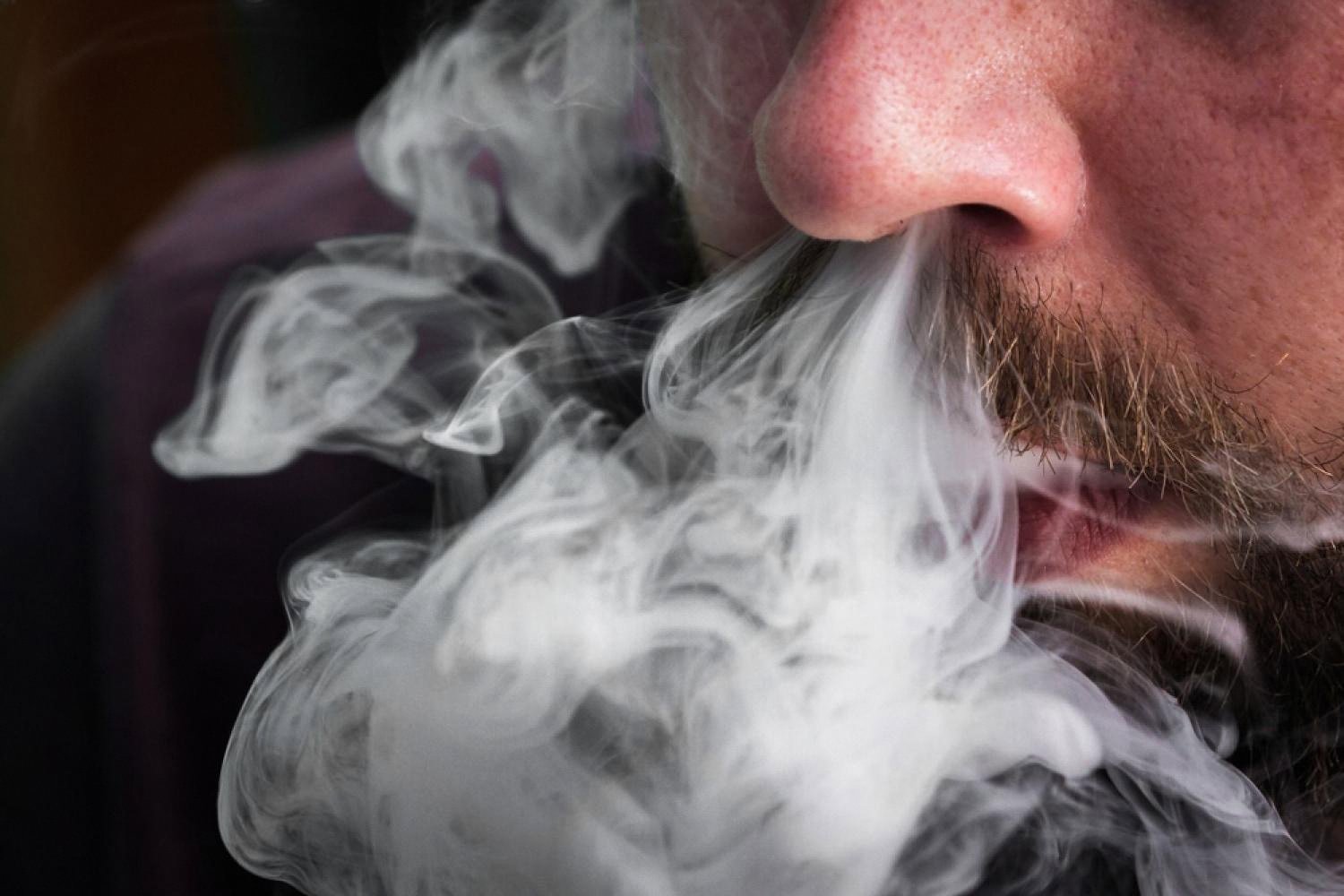 Close-up of a man exhaling vapour, illustrating nicotine consumer behaviour in the UAE